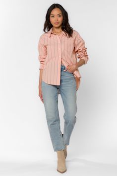 This Randall Peach Stripe Shirt is the perfect addition to your wardrobe. The long sleeve boyfriend shirt features a single chest pocket and a high low hem, making it both stylish and functional. The classic striped design adds a touch of sophistication to any outfit. Stay comfortable and fashionable with this must-have piece. Material: 100% Cotton Machine wash cold or hand wash Color: Peach Stripe Model is 5'9" and wearing a size S Imported Summer Peach Cotton Shirt, Peach Cotton Summer Shirt, Trendy Cotton Blouse With Spread Collar, Casual Pink Blouse With Shirttail Hem, Casual Peach Blouse For Fall, Cotton Shirt With Shirttail Hem, Trendy Cotton Blouse With Rolled Sleeves, Trendy Cotton Blouse With Shirttail Hem, Cotton Blouse With Shirttail Hem For Spring