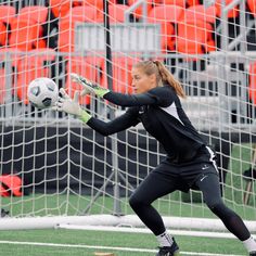 a female soccer goalie in action on the field