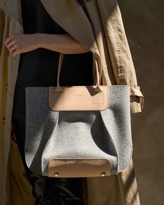 The Frankie Midi captures the inherent sculptural qualities and capabilities of 3mm merino wool felt construction. The Midi features smooth, sturdy vegetable-tanned leather handles and is accented with Italian nickel hardware. Single magnetic snap closure and two interior hanging pockets provide security and convenience to this highly functional piece. The Midi is the shoulder bag (https://graf-lantz.com/collections/womens) version of our architectural-inspired and dramatic design with premium hand-finishing for an elegant execution.

 To add a little extra flare and make your bag even more unique, why not add one of our Fobs (https://graflantz.com/collections/keychains).

 Benefits of Merino Wool Felt

  
 * Sustainable, biodegradable, and renewable 
 * Odor, stain, heat, and dirt-resista Wool Tote, Felt Tote, Felt Bags, Vegetable Leather, Oversized Tote, Commuter Bag, Diy Bags, Iconic Bags, Felt Bag