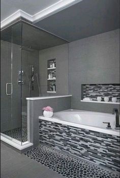 a bathroom with a walk in shower next to a bath tub