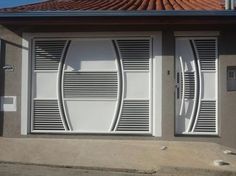 two white doors on the side of a house