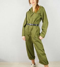 "Popper jumpsuits made for the British military. Look great pulled in with a belt as seen. They also have a drawstring waist which can be pulled in from the inside to give shape.  SIZING Womens model is size UK 8/10, waist 28\", chest 33\", hips 35\" and 5ft 6 for your reference, wearing size small a little oversized. Mens model is chest 36\", height 5ft 7 and wearing size small. X-Small: to fit chest 34\" / ladies UK 6-8  Small: to fit chest 34\"-36\"/ ladies UK 10-12 Medium: to fit chest 38\"-40\" / ladies UK 12-14 Large: to fit chest 42\"  / ladies UK 16 X-Large to fit chest 44\" / ladies UK 18  2XL: to fit chest 46\" - 48\" / ladies UK 20-22  CONDITION Great vintage condition. POSTAGE - We aim to dispatch within 1-2 working days for you. - Free UK postage and automatic shipping discoun Cargo Style Jumpsuits And Rompers For Workwear In Fall, Utility Style Khaki Jumpsuits And Rompers For Fall, Fall Cargo Style Overall Jumpsuits And Rompers, Utility Style Khaki Jumpsuit For Work, Khaki Utility Jumpsuits And Rompers For Workwear, Khaki Utility Jumpsuit For Work, Utility Style Belted Jumpsuit For Fall, Fall Workwear Cargo Jumpsuits And Rompers, Green Utility Jumpsuits And Rompers For Work