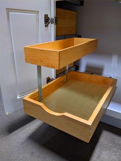 two wooden drawers are stacked on top of each other