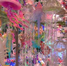 an assortment of colorful glass ornaments hanging from the ceiling