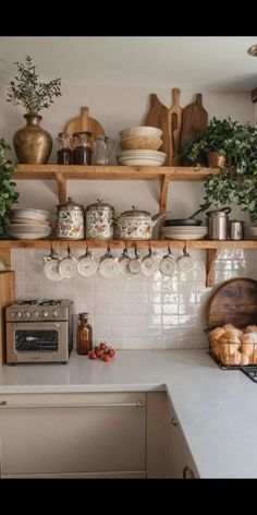 a kitchen filled with lots of pots and pans on top of shelves next to a counter