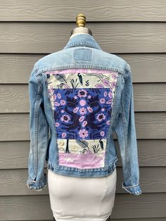 a woman's jean jacket with flowers on it