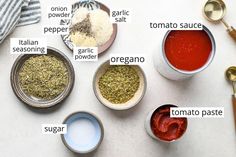 spices and seasonings in small bowls on a counter top with spoons, salt, pepper, garlic, tomato paste, sugar, paprit