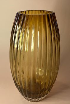 a yellow glass vase sitting on top of a table