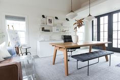 a living room with a couch, table and chairs