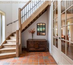 an entry way with stairs leading up to the second floor