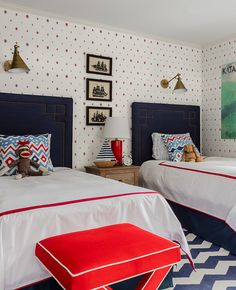 two beds in a bedroom with red, white and blue decor