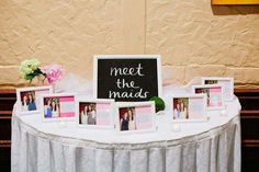 a table topped with pictures and flowers next to a sign that says meet the mads