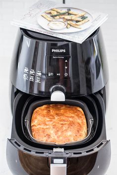 an air fryer with food in it sitting on top of a counter next to a napkin