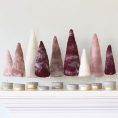 five different colored cones are lined up on top of each other in front of a fireplace