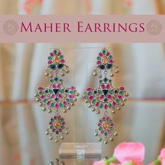 Get your traditional look right! Stunning tribal style earrings encrusted with shimmering stones. Approximate earrings length is 3.5". Designed over a high-quality brass as base metal. Maher Earrings (Ruby) are in-stock & ready-to-ship. Delivery time frame for the Maher Earrings (Multicolor) is 4-6 weeks. For custom or urgent requests, please contact support@alacouture.com. *Please Note: We use faux stones and beads in all of our jewelry. Temple Jewelry Style Metal Chandelier Earrings, Metal Temple Jewelry Chandelier Earrings, Metal Chandelier Earrings With Latkans In Temple Jewelry Style, Festive Metal Jeweled Earrings, Traditional Dangle Chandelier Earrings, Silver Jeweled Earrings For Festive Occasions, Silver Jeweled Chandbali Earrings, Silver Chandbali Earrings With Jewels, Silver Jeweled Bridal Earrings For Festivals