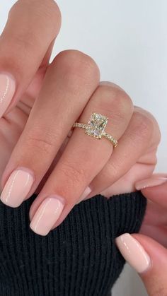 a woman's hand with pink manies and a diamond ring on her finger