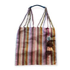 We have brought the quintessential Mexican striped hammock bag with pom pom home with us in an array of enticing colors. The woven yarns in the purse are braided to become the straps that lead up to a comfortable finished shoulder strap. This is the purse that your friends will be asking where you got it! Hand selected and imported from Guanajuato, Mexico. Entirely handwoven on traditional Maya looms, it takes an artisan an entire days worth of weaving to complete one striped hammock bag. • Double sided stripes • Finished off with a coordinating pom and 3 tassel flourish • overall: 15" x 26 , purse only: 15" x 15" • Each purse is one of a kind. Once it's sold, it's gone. Striped Woven Rectangular Shoulder Bag, Rectangular Striped Woven Shoulder Bag, Striped Woven Tote Bag, Striped Woven Travel Bag, Woven Striped Travel Bag, Striped Woven Bags For Daily Use, Handwoven Striped Bags For Vacation, Handwoven Striped Bags For Everyday Use, Everyday Handwoven Striped Bags