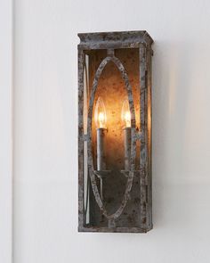 an old fashioned wall light with two candles