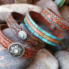 three bracelets sitting on top of some rocks