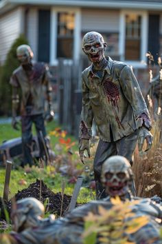 the walking dead statues are in front of a house with their heads turned to look like zombies