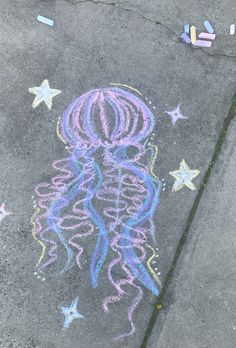 a chalk drawing of a jellyfish and stars on the sidewalk with crayons