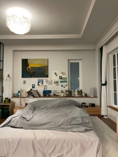 a bed sitting in a bedroom next to a window