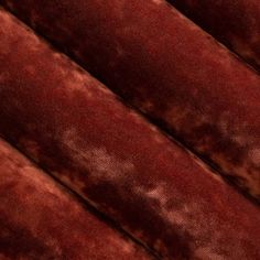 a close up view of a red velvet textured material that looks like it has been dyed