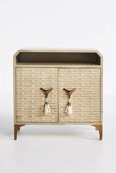 a wooden cabinet with two birds on it