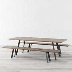 two wooden benches sitting on top of a hard wood floor