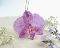 a purple flower sitting on top of a table