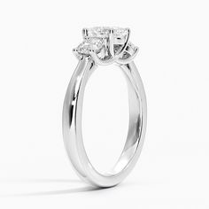 a white gold engagement ring with an oval cut diamond in the center and side stones