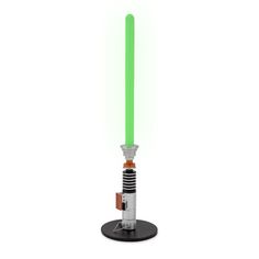 a green light saber is on top of a black stand with a white base and two orange lights