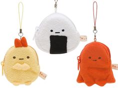 three small stuffed animals hanging from hooks