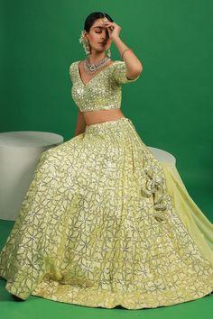 Lemon yellow lehenga with attached can can and sequin embroidered floral motifs. Comes with padded blouse and dupatta.
Components: 3
Pattern: Embroidered
Type Of Work: Thread, Sequin
Neckline: V-neck
Sleeve Type: Half
Fabric: Georgette
Color: Yellow
Other Details: 
Attached lining
Lehenga Length: 42 inches
Model Height: 5ft 4inches wearing size S
Closure: 
Lehenga: Side drawstring
Blouse: Back hook
Occasion: Mehendi and Haldi,Sangeet - Aza Fashions Lemon Yellow Lehenga, Sequin Lehenga, Yellow Lehenga, Blouse Back, Padded Blouse, Can Can, Lemon Yellow, Floral Motifs, Set For Women