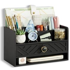 an organized desk drawer with office supplies on it