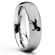 a wedding ring with the silhouette of a dog on it, and an inscription that reads so