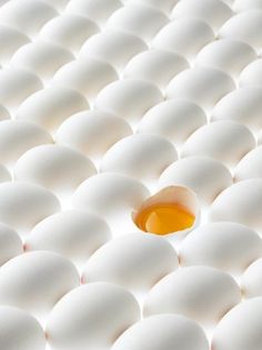 an egg laying on top of a white mattress