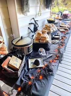 a table topped with lots of food on top of a wooden floor next to a building