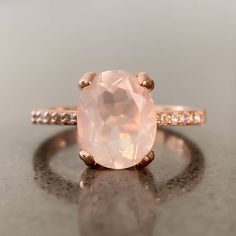 Crafted in 14K rose gold over silver, this breathtaking ring features an oval-shaped natural rose quartz stone. The shank glistens with petite cubic zirconia to complete the design. Being a stone of unconditional love, Rose Quartz will purify and open your heart at all levels to promote harmony, deep inner healing and feelings of peace. Rose Quartz Engagement Ring, Rose Quartz Ring Engagement, Watermelon Tourmaline Ring, Quartz Engagement Ring, Open Your Heart, Rose Gold Crystal, Inner Healing, Rose Quartz Ring, Rose Quartz Stone