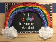 a bulletin board that says, be a rainbow in someone else's cloud