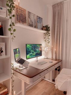 a desk with two computers on it in front of a window and bookshelf