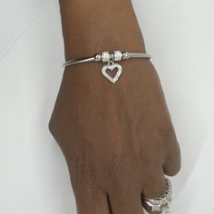 Product Details - Stainless steel with cubic zirconia heart charm - Fits wrists up to 7.5 inches Bracelet Stacks, Bracelet With Heart, Basic Girl, Silver Heart Bracelet, Silver Jewelry Box, Stainless Steel Bangles, Cute Bikinis, Dream Jewelry, Heart Bracelet