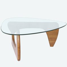 a glass table with wooden legs and a curved top is shown in front of a white background