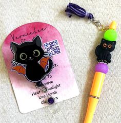 This is the perfect Halloween badge reel and pen set for the Halloween lover and cat lover all in one. I made using an acrylic blank, glitter, patterned vinyl, plain vinyl and a badge reel  For the pen I used silicone beads and a cute silicone cat focal and then I added a little tassel, it comes with one refill  I use high quality products and test the badge reels before attaching to the back but I cannot guarantee the life of the reel  Size of the blank.  2 inch Novelty Black Craft Supplies Gift, Themed Black Badge Reel Gift, Customizable Black Badge Reel, Novelty Black Badge Reel For Halloween, Coworker Birthday Gifts, Customizable Black Novelty Badge Reel, Black Badge Reel, Halloween Gift, Patterned Vinyl, Id Holder