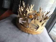 a gold crown sitting on top of a cushion