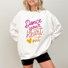 This cute Dance Your Heart Out sweatshirt is also available in a Comfort Colors® T shirt style. Visit our shop to see them and more dance sweatshirts & Dance shirts! ▸ Gildan Brand Sweatshirt in WHITE   ▸ Unisex Adult Sizing   ▸ 50% Cotton, 50% Polyester ▸ Medium-Heavy Fabric ▸ Rolled Sleeves in pictures is for styling purposes only   ▸ Props used In photos are NOT included with purchase SIZE ▸ Take a look at the photos to see a specific sizing chart for this sweatshirt style ▸ Please note that these sweatshirts are unisex size meaning they are not women's fitted sweatshirts ▸ Lay your favorite sweatshirt at home flat and measure armpit to armpit to compare to the size chart in the photos Dance Studio Merchandise, Dance Shirts Ideas Dancers, Casual Letter Print Sweatshirt For Dance, Crew Neck Sweatshirt With Letter Print For Dance, Graphic Print Crew Neck Sweatshirt For Dance, Crew Neck Graphic Print Sweatshirt For Dance, White Crew Neck Top For Dance Class, Casual Crew Neck Sweatshirt For Dance, White Casual Dance Top