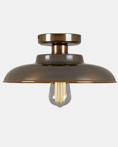 an industrial style light fixture with a brass finish