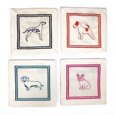 four different colored dogs on white linen napkins