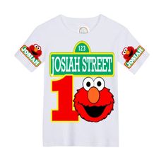 the sesame street number one tee shirt is white with red, yellow and green letters