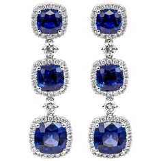 This extravagant dangle drop earrings features a row of cushion cut blue sapphires weighing 4.51 carats total, each set in a brilliant diamond halo. Diamonds weigh 0.73 carats total. Made in 18k white gold. Roman Malakov is a custom house, specializing in creating anything you can imagine. If you would like to receive a special quote on a custom piece please message or call us. Luxury Halo Design Earrings For Evening, Luxury Blue Statement Earrings, Luxury Handcrafted Blue Earrings, Luxury Glamorous Blue Jewelry, Luxury Blue Bridal Earrings, Luxury Blue Jewelry From Macy's, Luxury Blue Earrings For Celebrations, Luxury Costume Jewelry With Matching Earrings, Luxury Sapphire Earrings For Evening